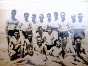 Ken and comrades, showing off their muscles in desert sun. I think he is 4th from right standing.