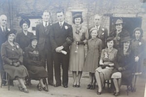 The wedding. Alice Dale seated second from left. Best man Ken Buckingham, Ken, Eileen (in a pink crepe dress, bolero jacket and hat, with two orchids), Bill Minchin. At front Thelma, Peggy and May.
